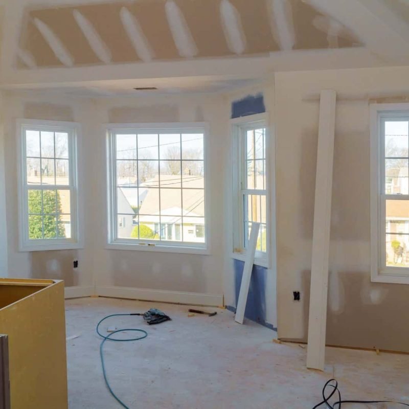 Newly built house interior with windows and drywall installation.